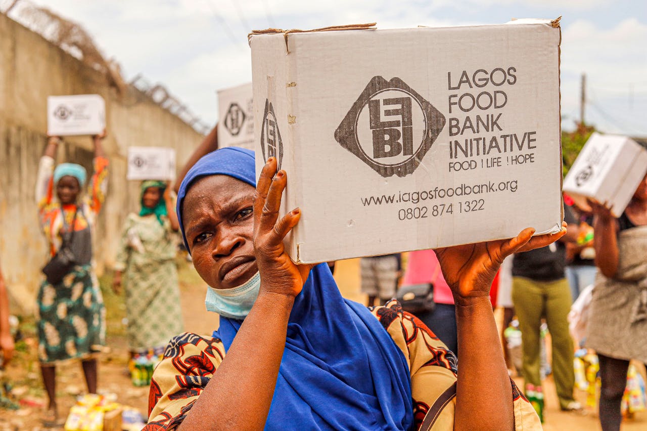 about-us Community members engage in food distribution at Lagos Food Bank initiative event.